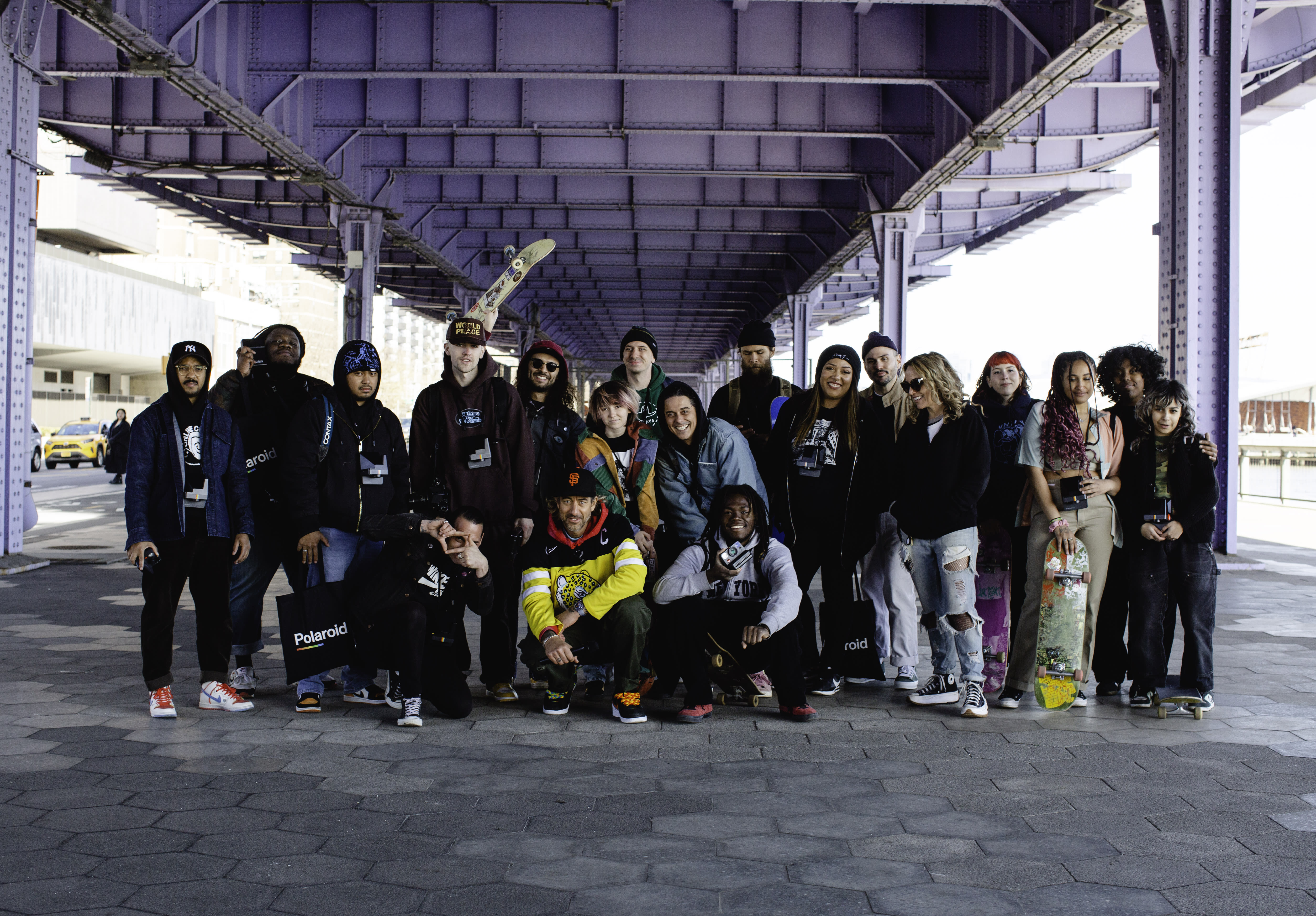 Brian Anderson poses with photographers for a New York City workshop on the Polaroid x Nike SB Dunk Low