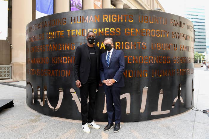 Masai Ujiri and John Tory stand outside the &#x27;Humanity&#x27; art installation in front of Union Station