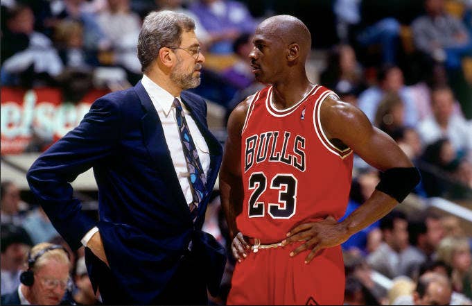Michael Jordan discusses strategy with head coach Phil Jackson