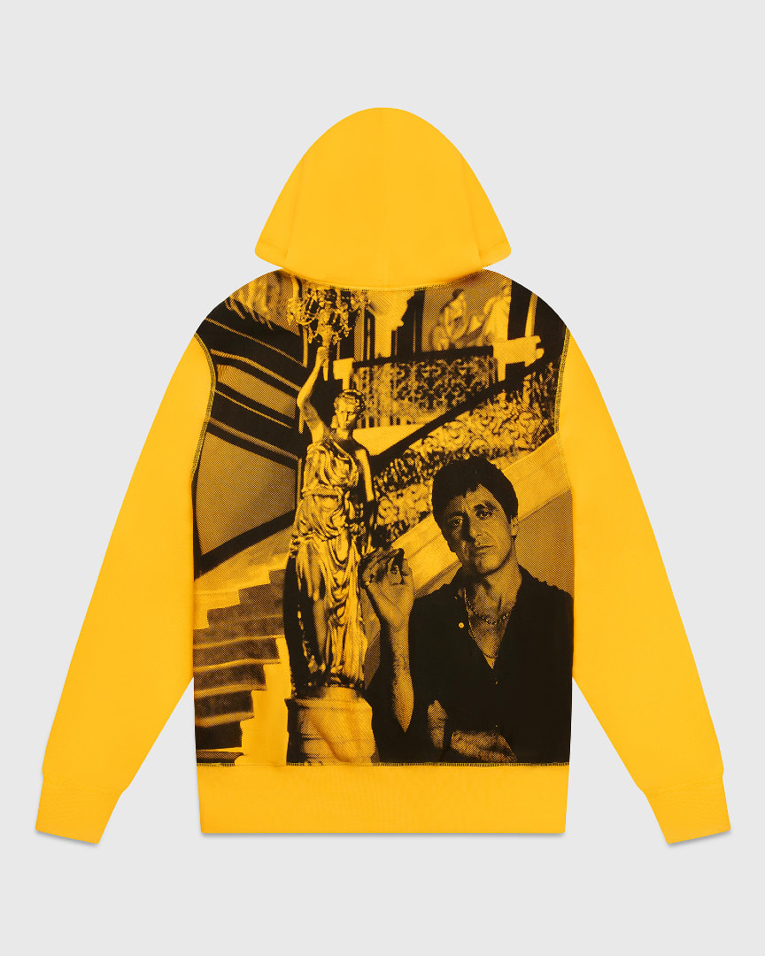 A yellow hoodie featuring a photo of Tony Montana (Al Pacino) holding a cigar.