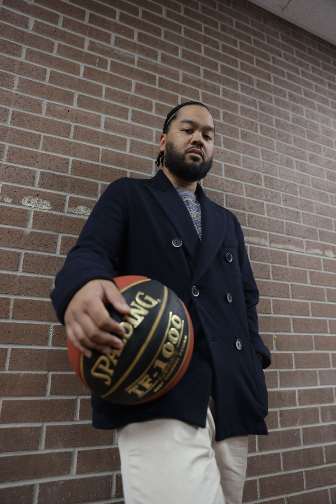 Drake affiliate OVO Niko poses with a basketball