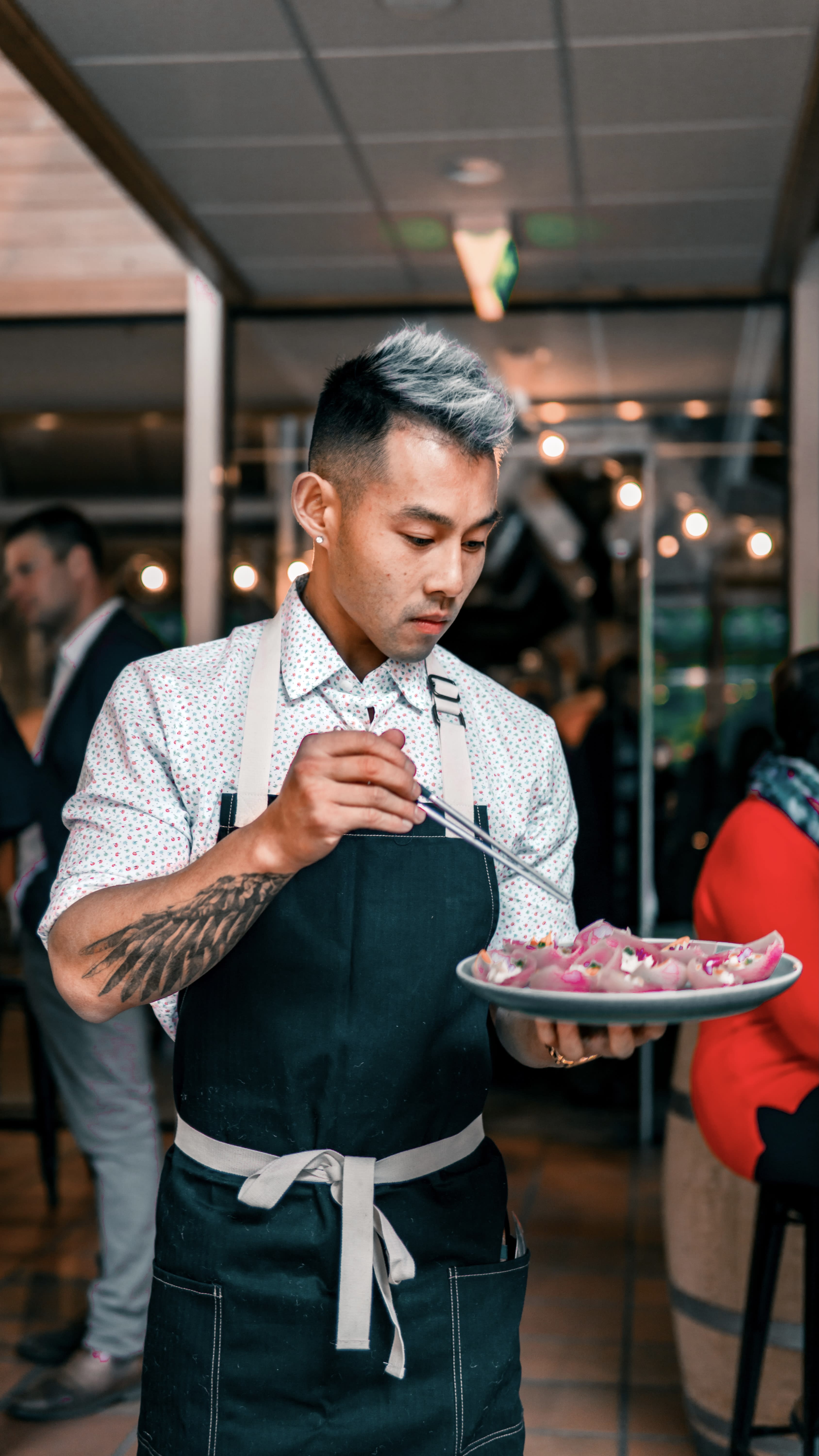 Wallace Wong using chopsticks to sort dish