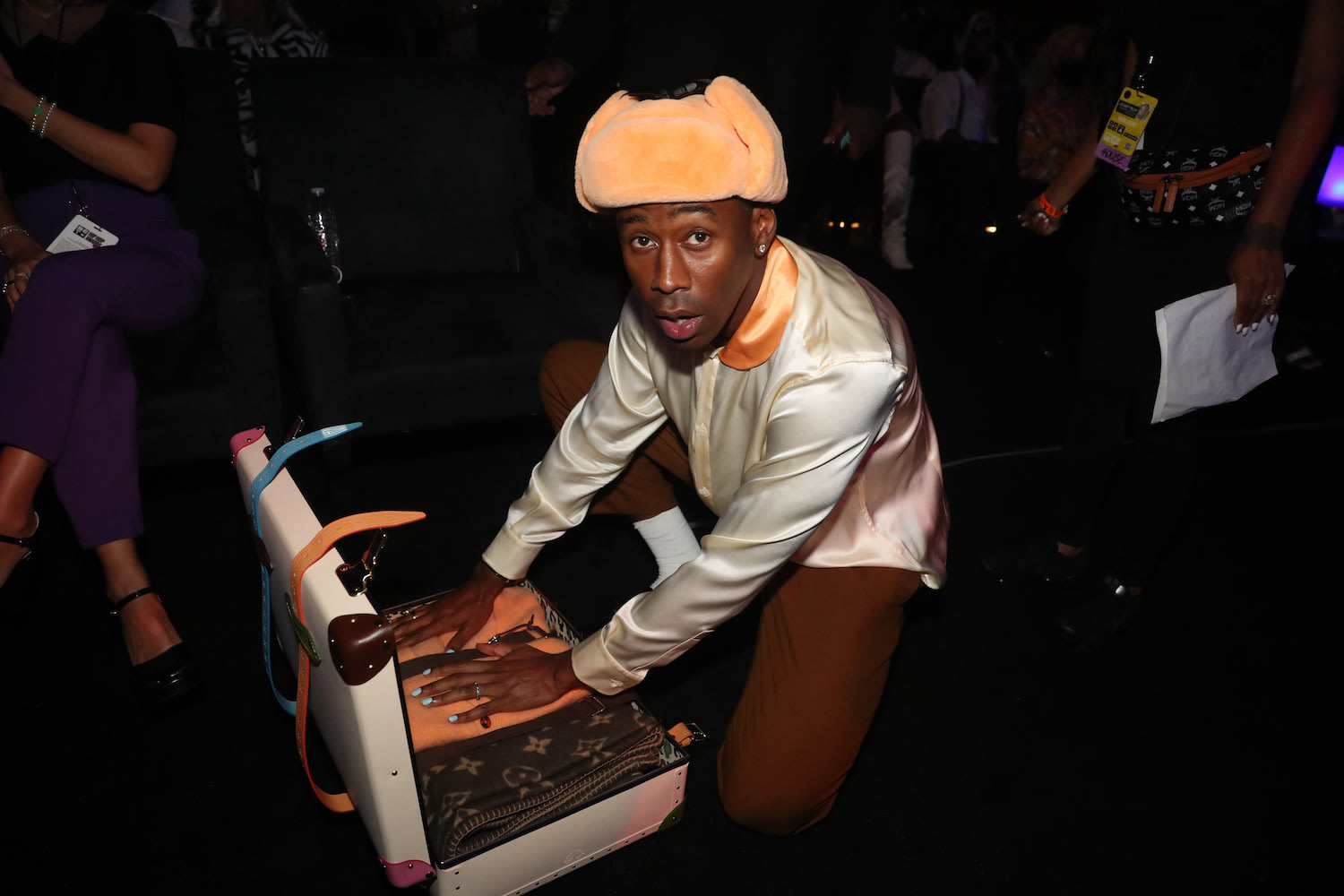 Tyler, The Creator Opening a Globe-Trotter x Golf le Fleur Suitcase