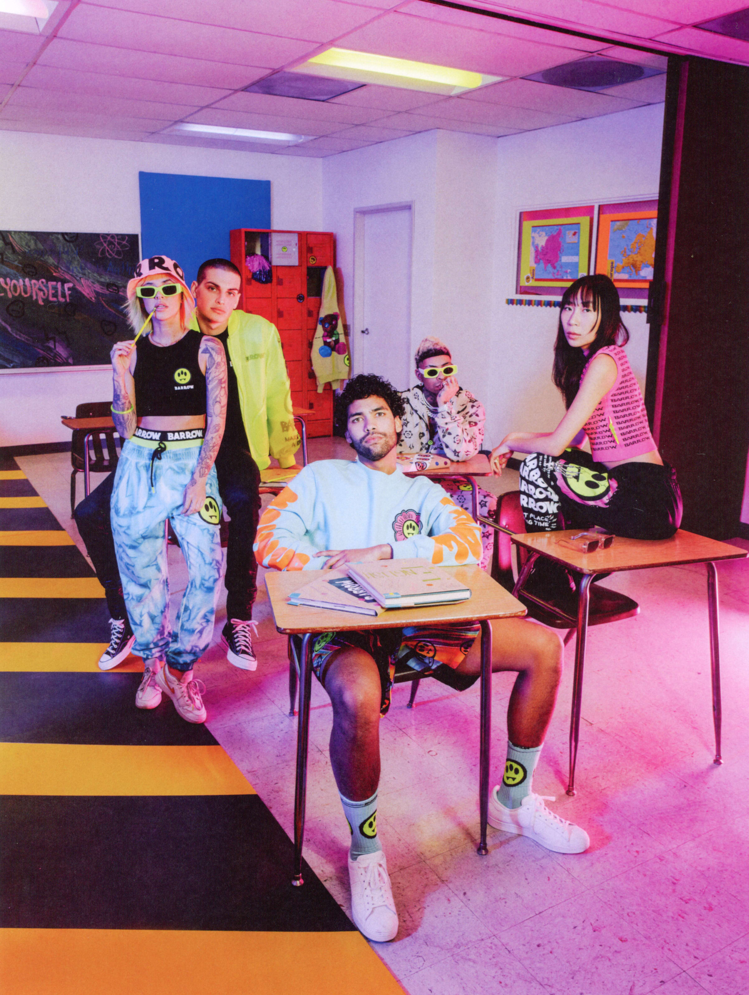 Influencers dressed in neon clothes in a classroom