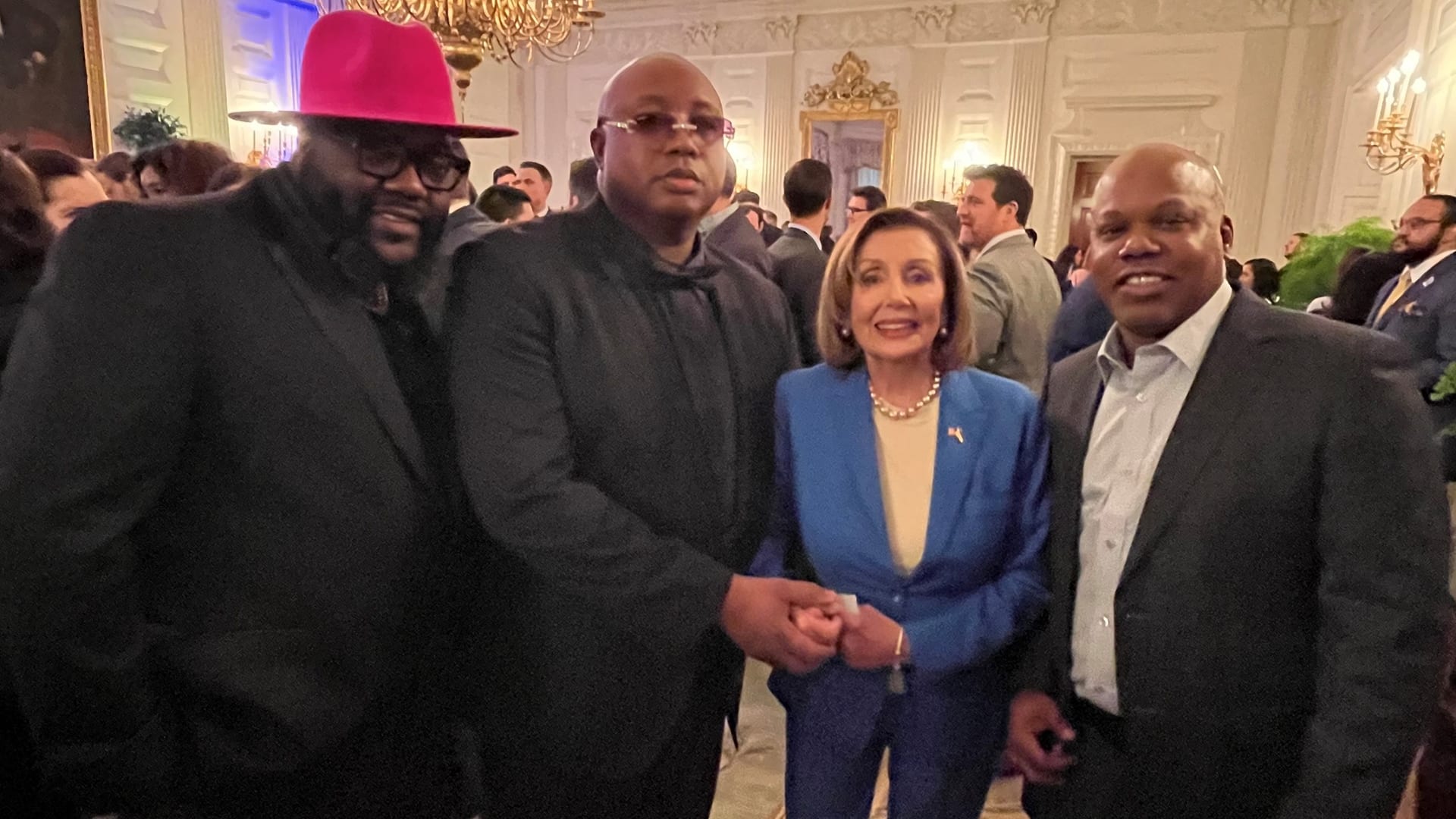 E-40, Too Short and Nancy Pelosi take a photo together.