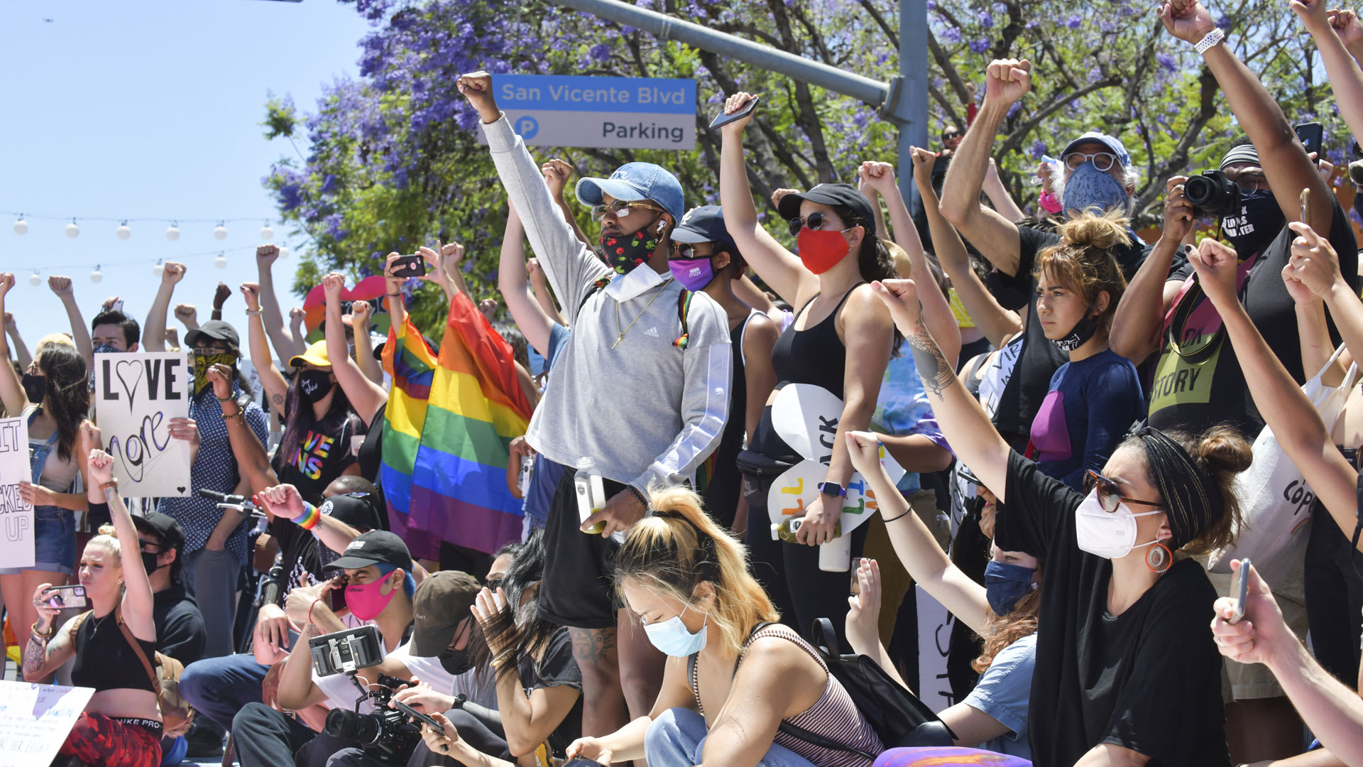 Protesters raise their fists in solidarity.