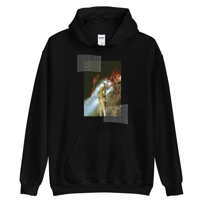A black hoodie with an image of Tynomi Banks with repeated phrases in white text