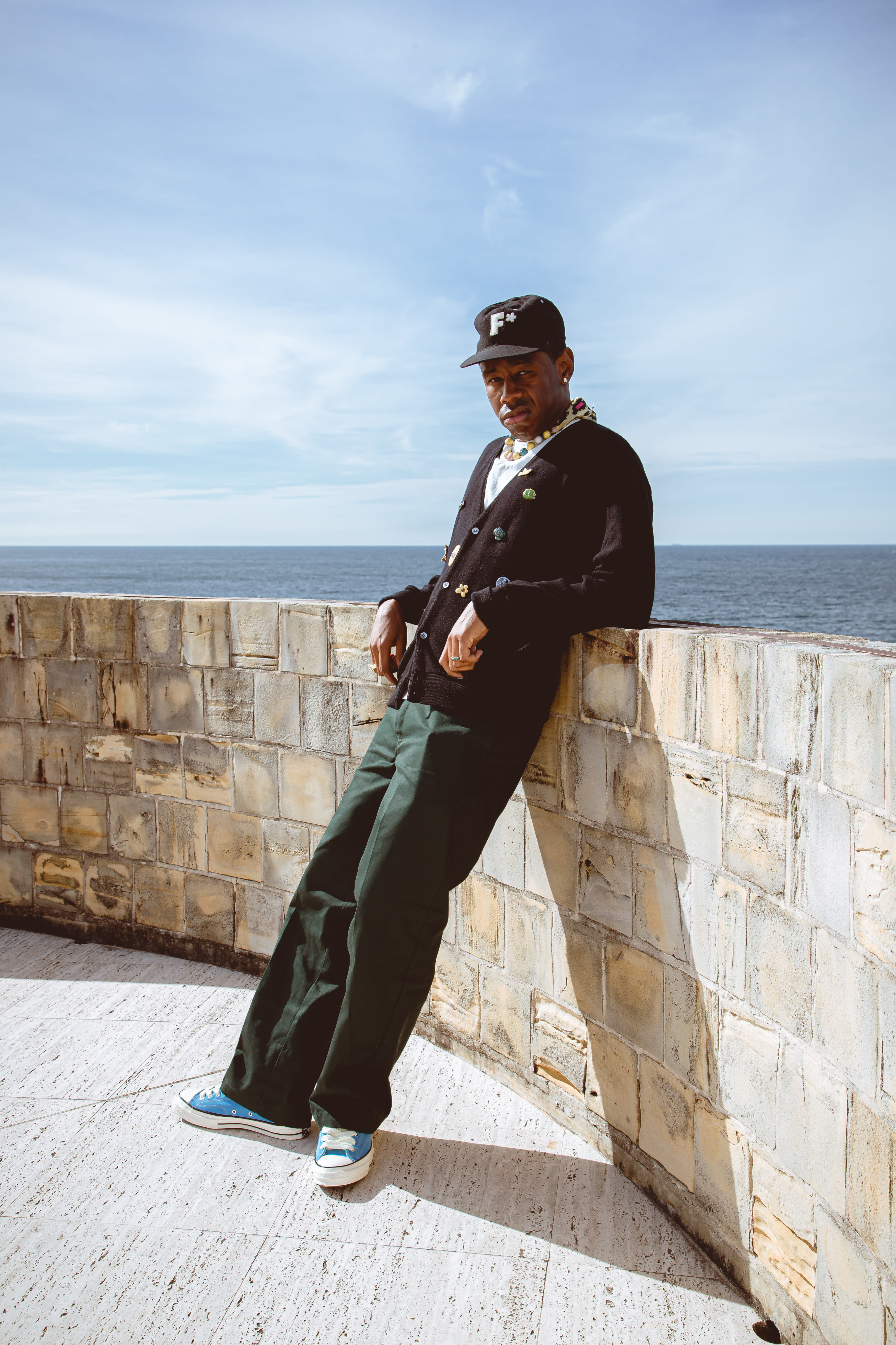 Tyler the Creator leaning against a wall in Sydney