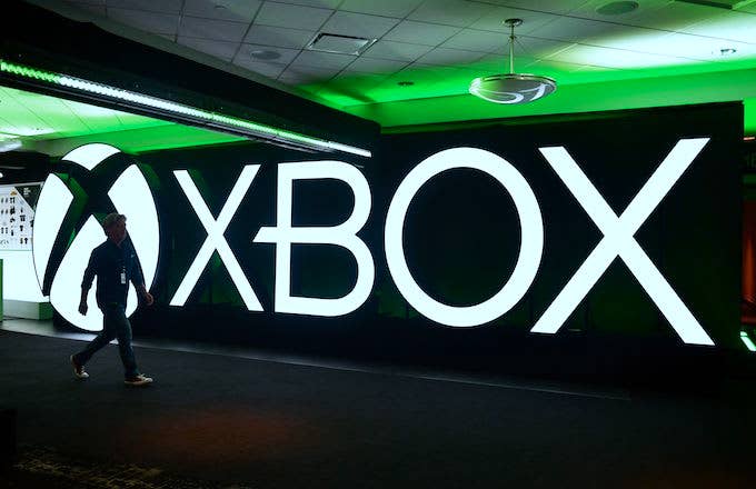 Man walks past an Xbox sign during the Xbox 2018 E3 briefing.