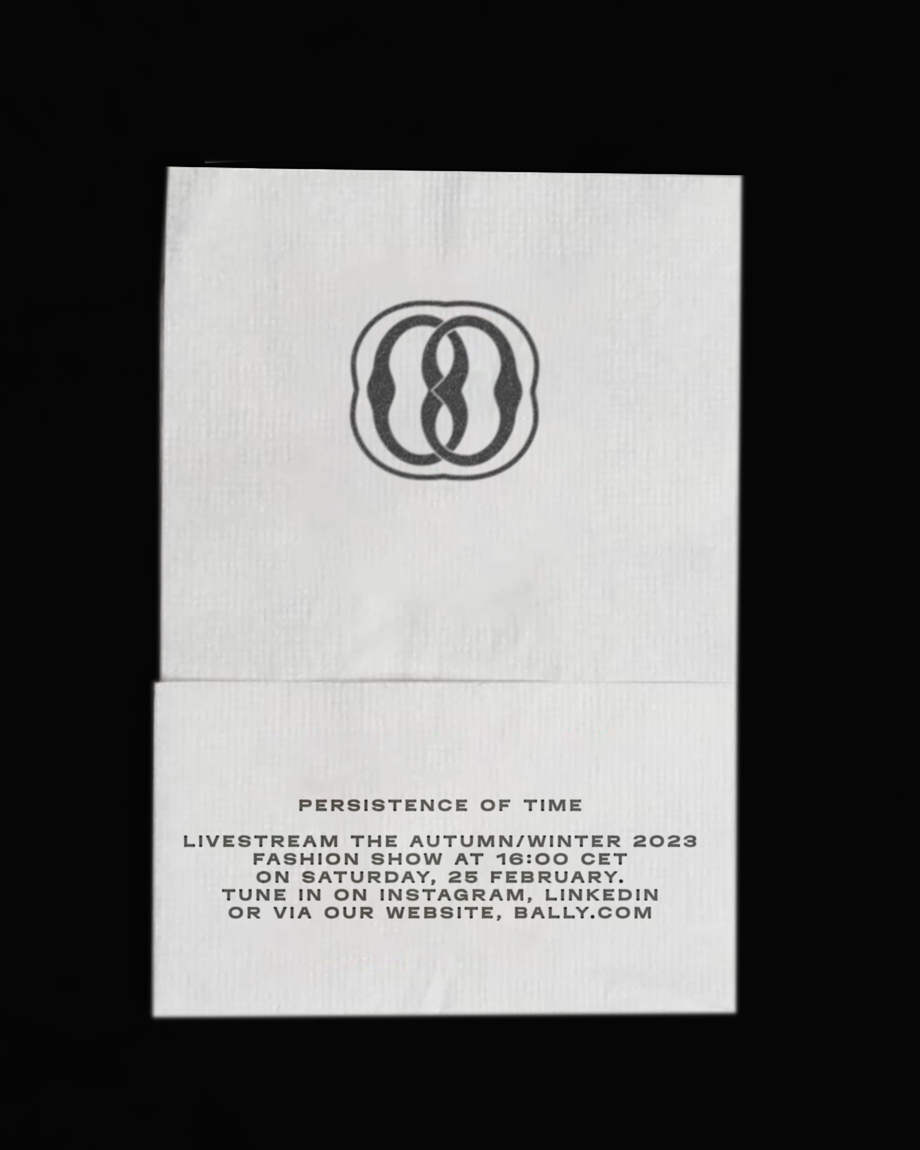 A picture of Bally&#x27;s AW 2023 milan show invitation on a napkin.