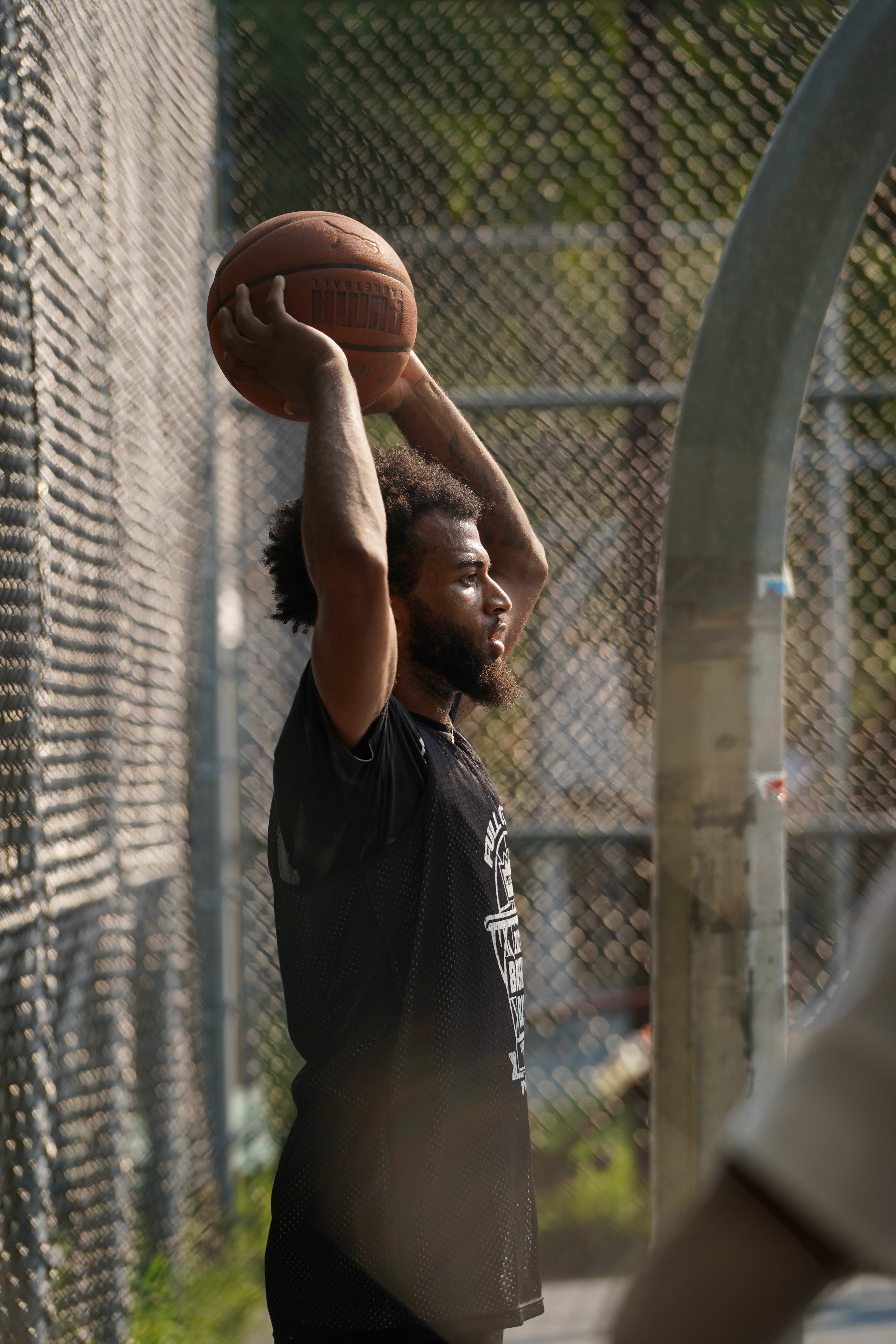 Man holding basketball above his head