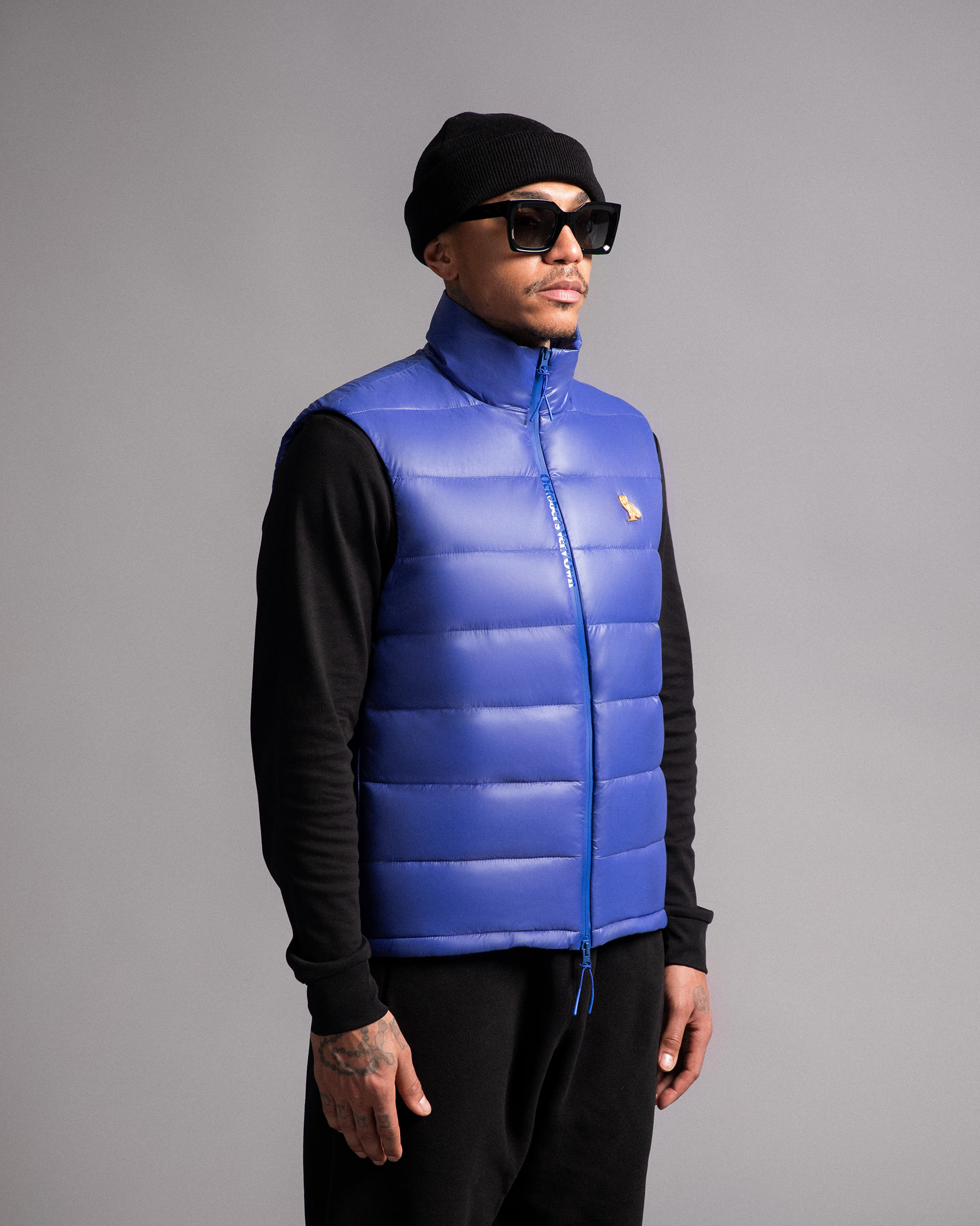 Model in blue puffer vest