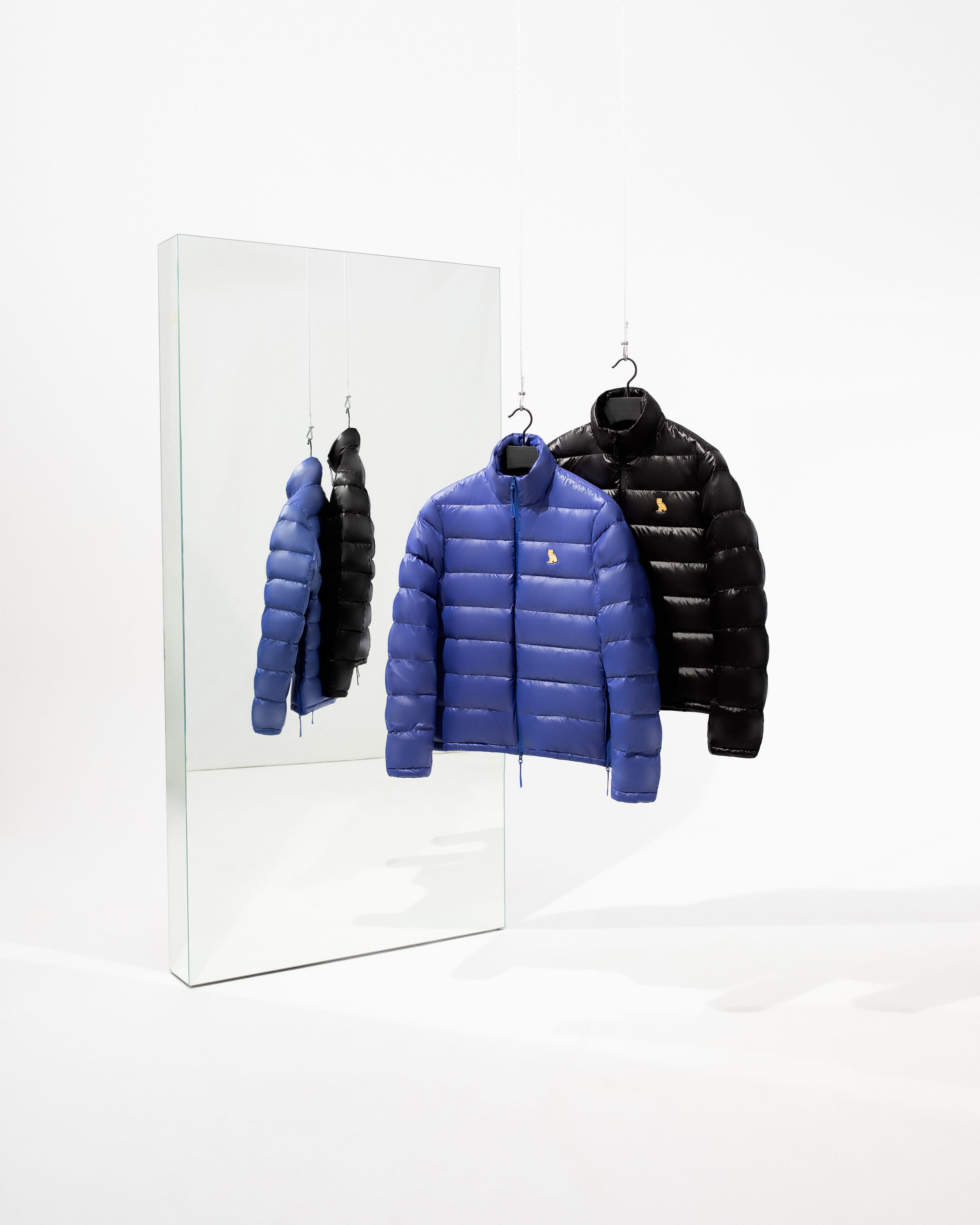 Blue and black puffer jackets hanging