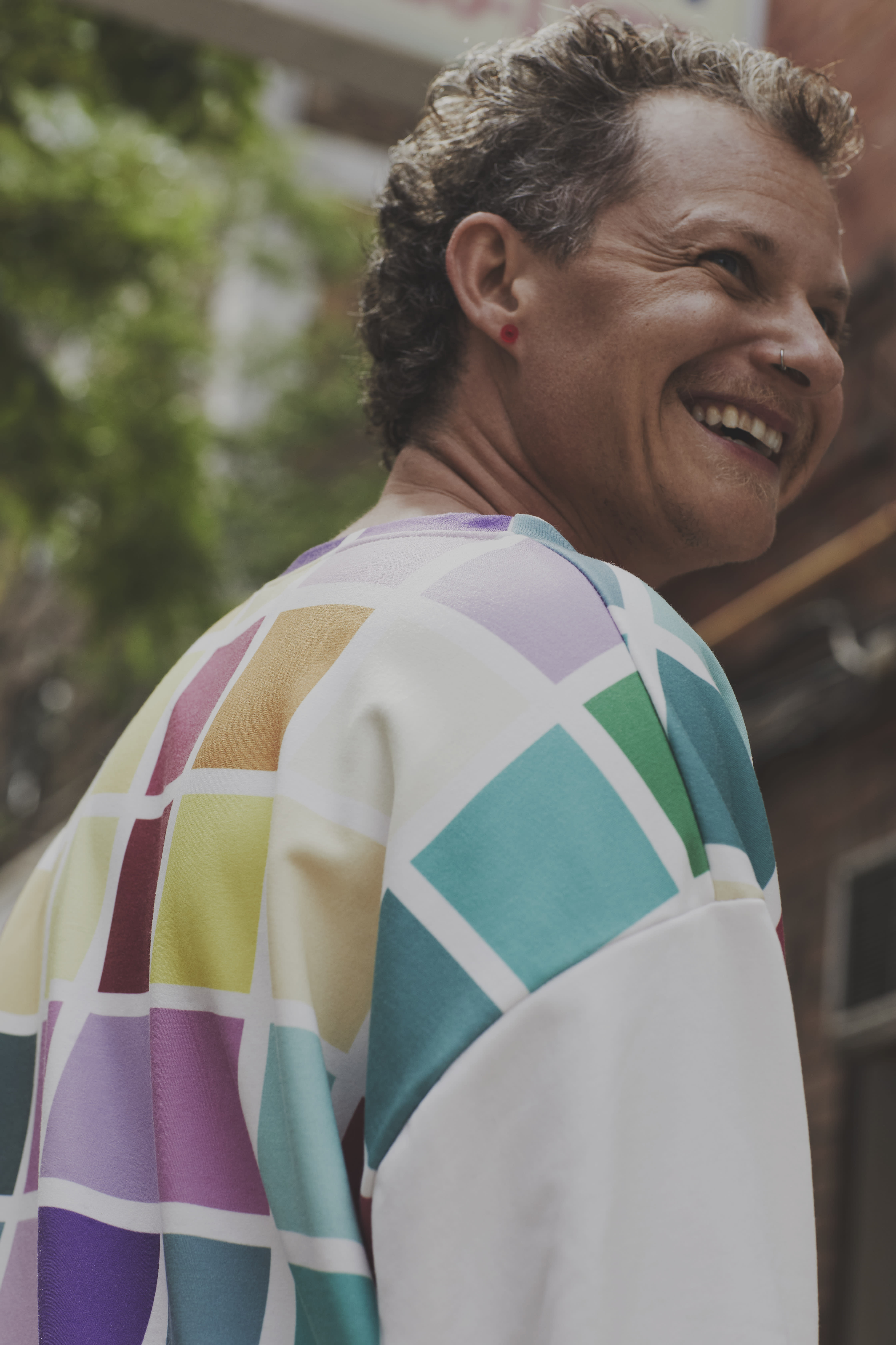 Tyler Lumb wearing a rainbow sweatshirt