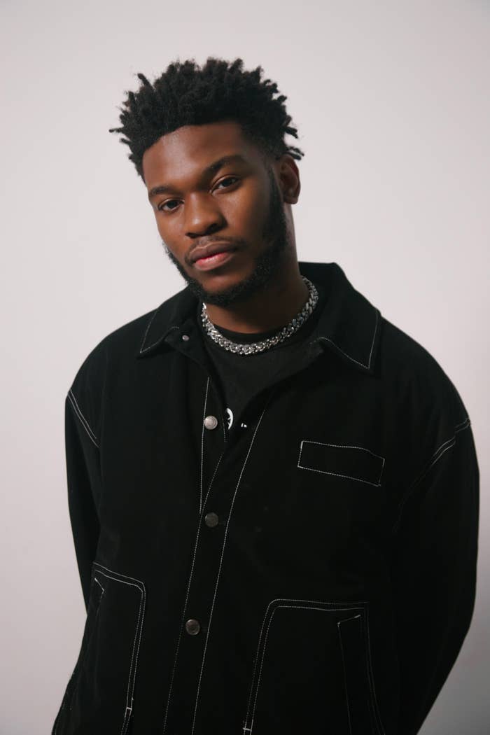 Nonso Amadi in a silver necklace and black jacket