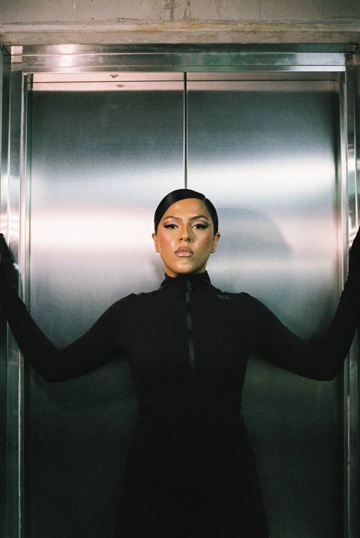 Pania in front of an elevator in black