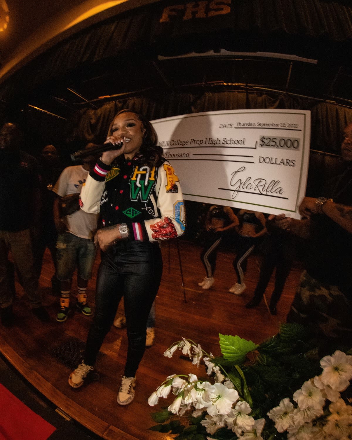 GloRilla with the big check behind her