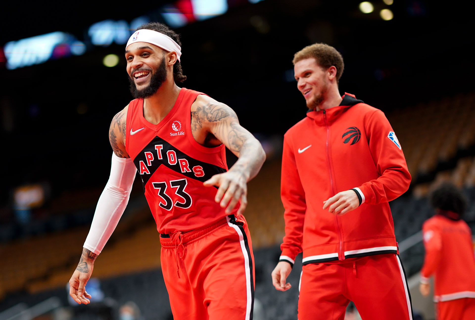 Gary Trent Jr. #33 and Malachi Flynn #22 of the Toronto Raptors smile before playing the Portland Trail Blazers