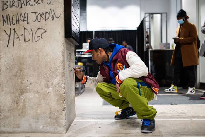 Don C signing a wall in a Foot Locker in Toronto