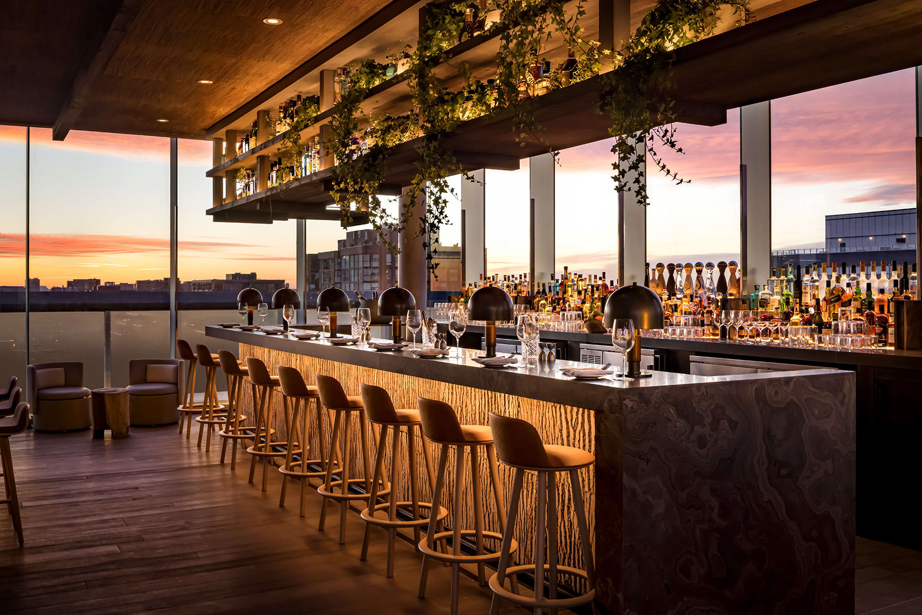 Rooftop bar with chairs and a sunset