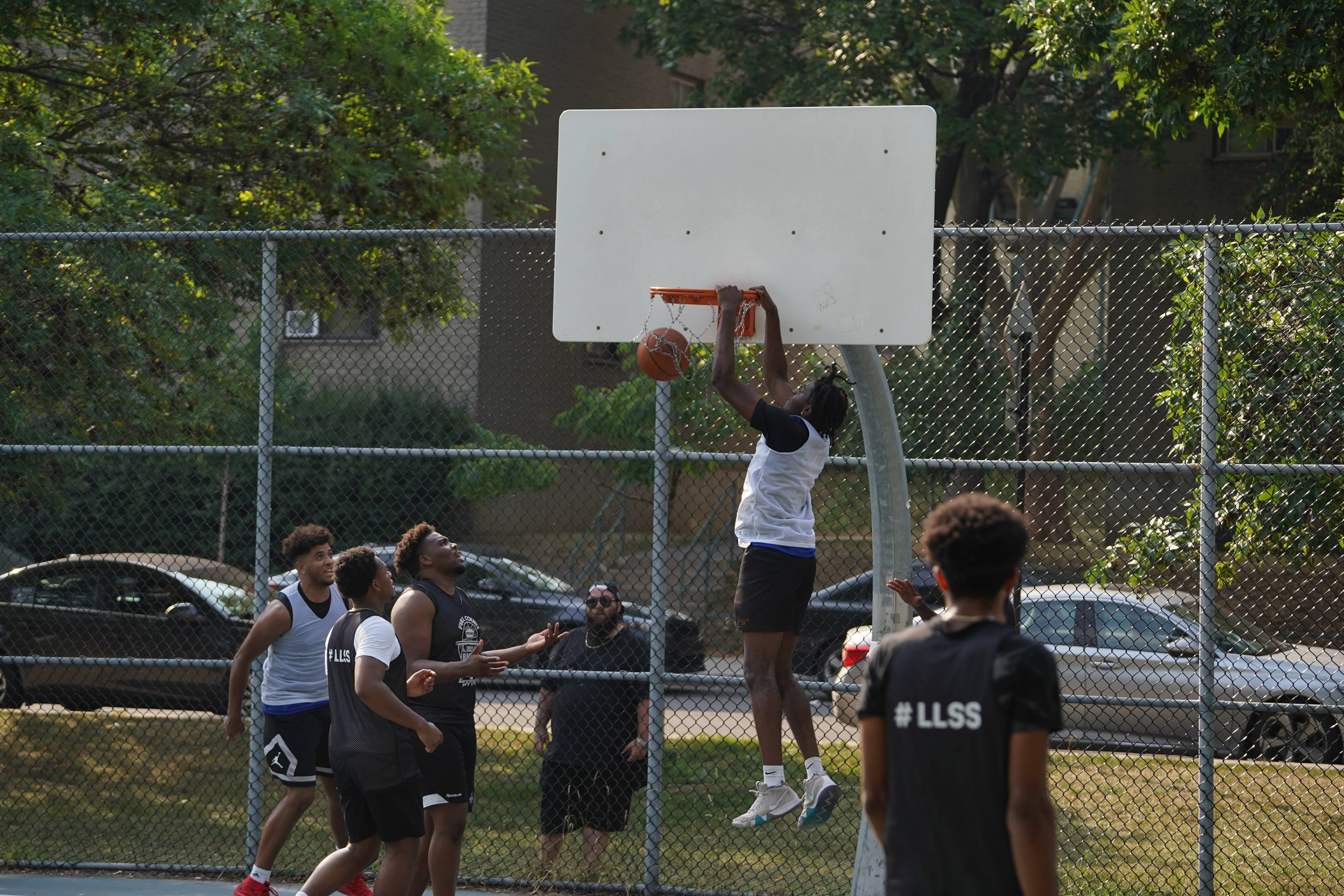 A player hanging off the basketball hoop