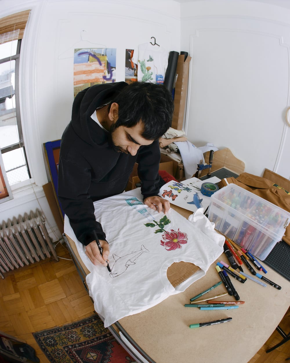 Nicholas Wlliams, the founder of Small Talk Studio, drawing a T-shirt.
