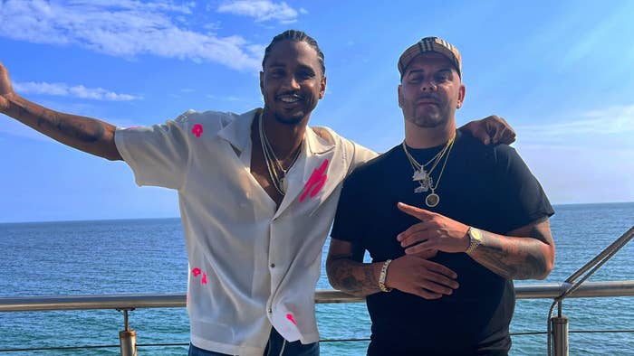 Trey Songz and Peter Jackson in front of water