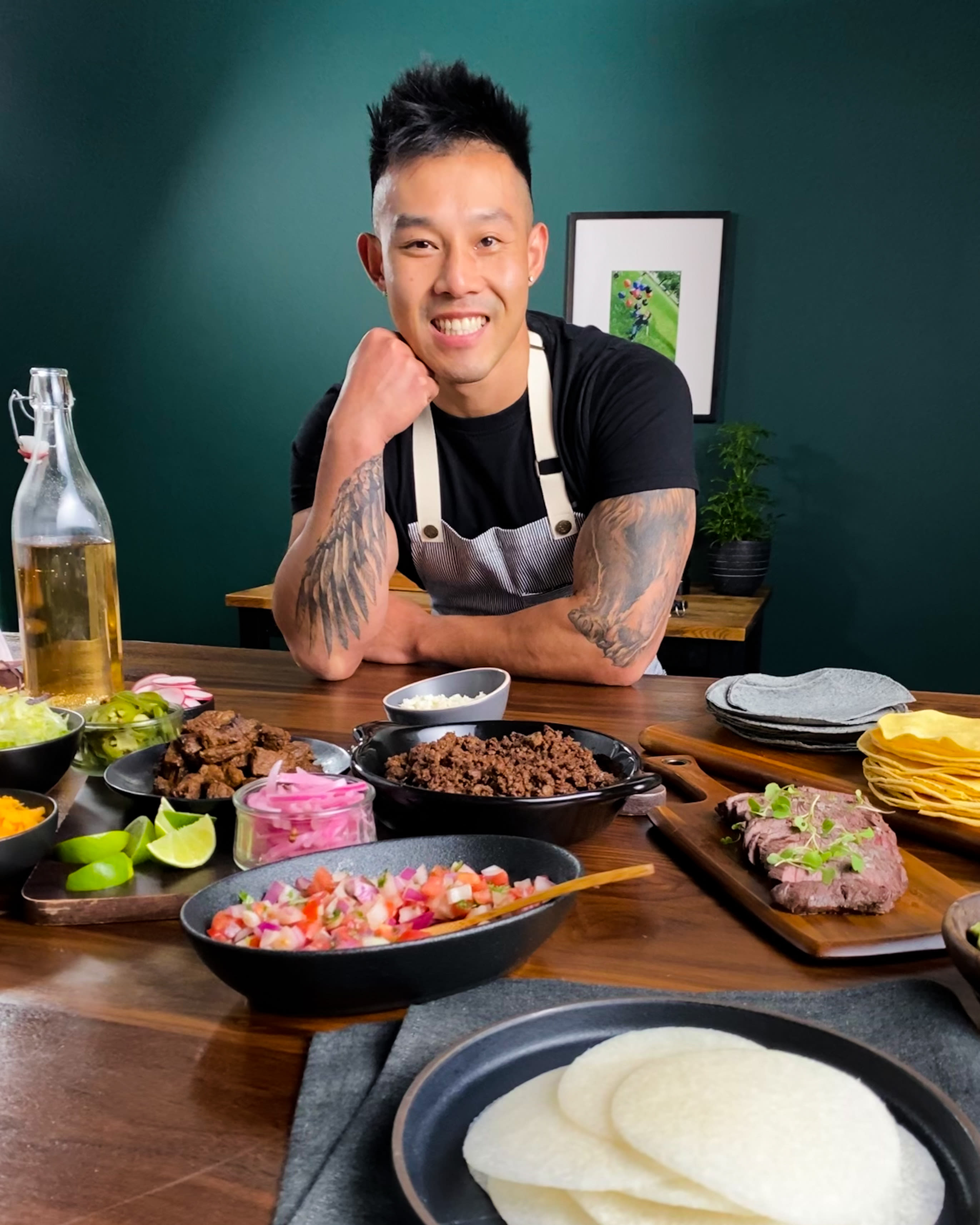 Wallace Wong posing over assorted food