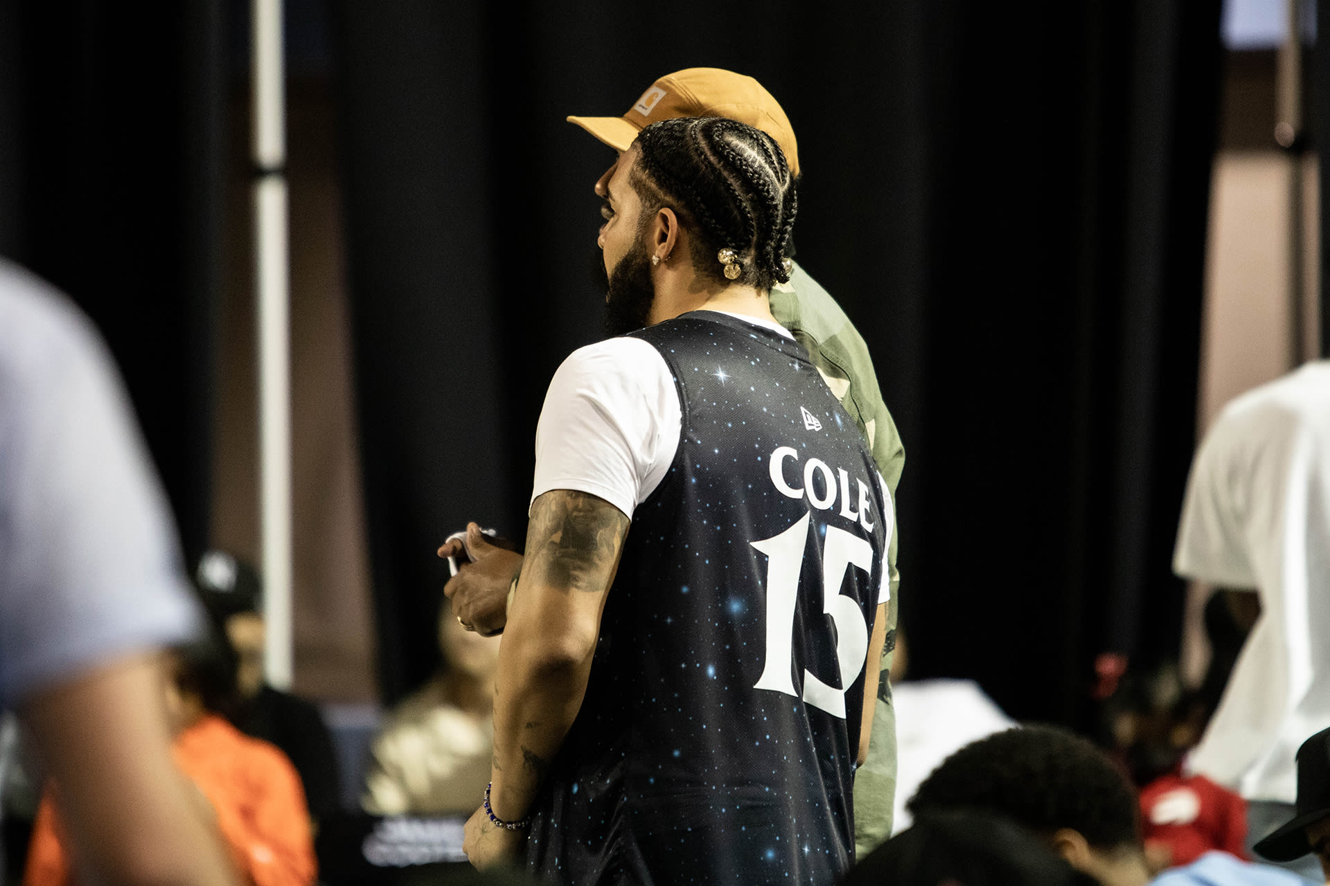 Drake wearing a J. Cole jersey at Scarborough Shooting Stars game