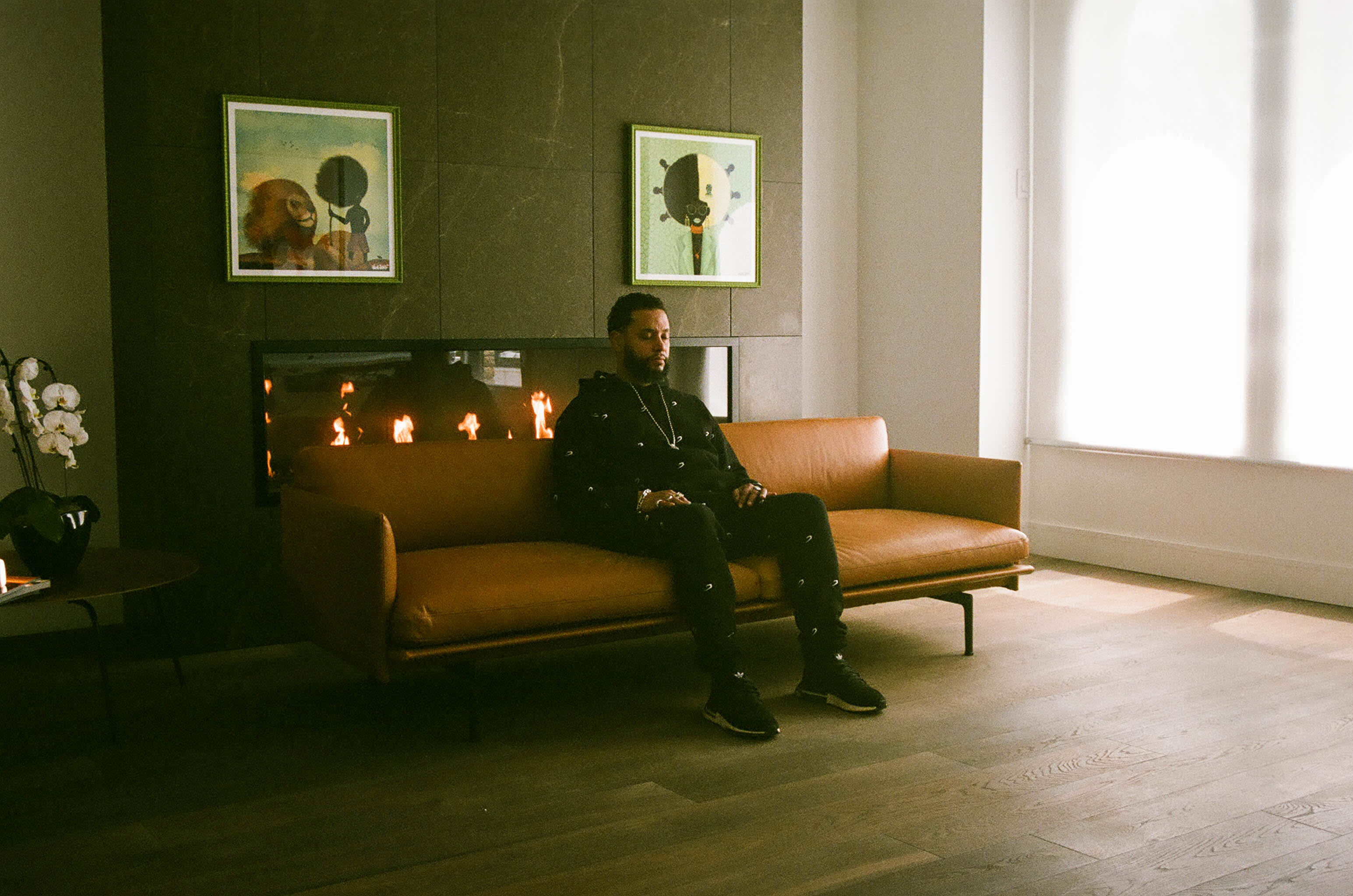 Director X sitting on a sofa