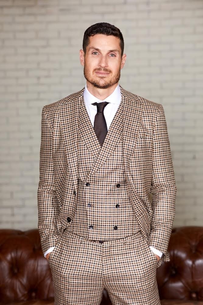 Tosh Berman wearing a brown checker-print suit