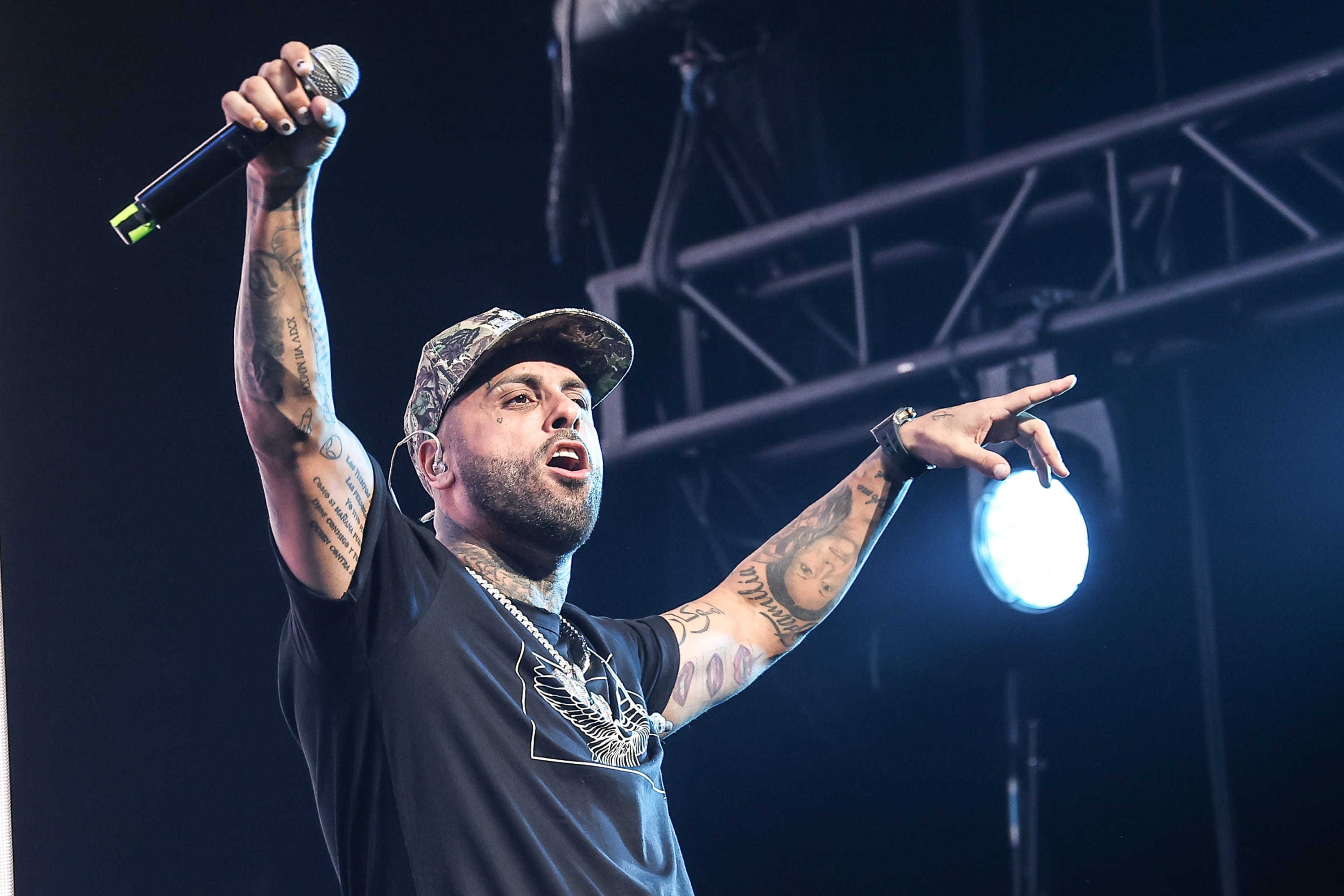 Nicky Jam performing on stage with a microphone