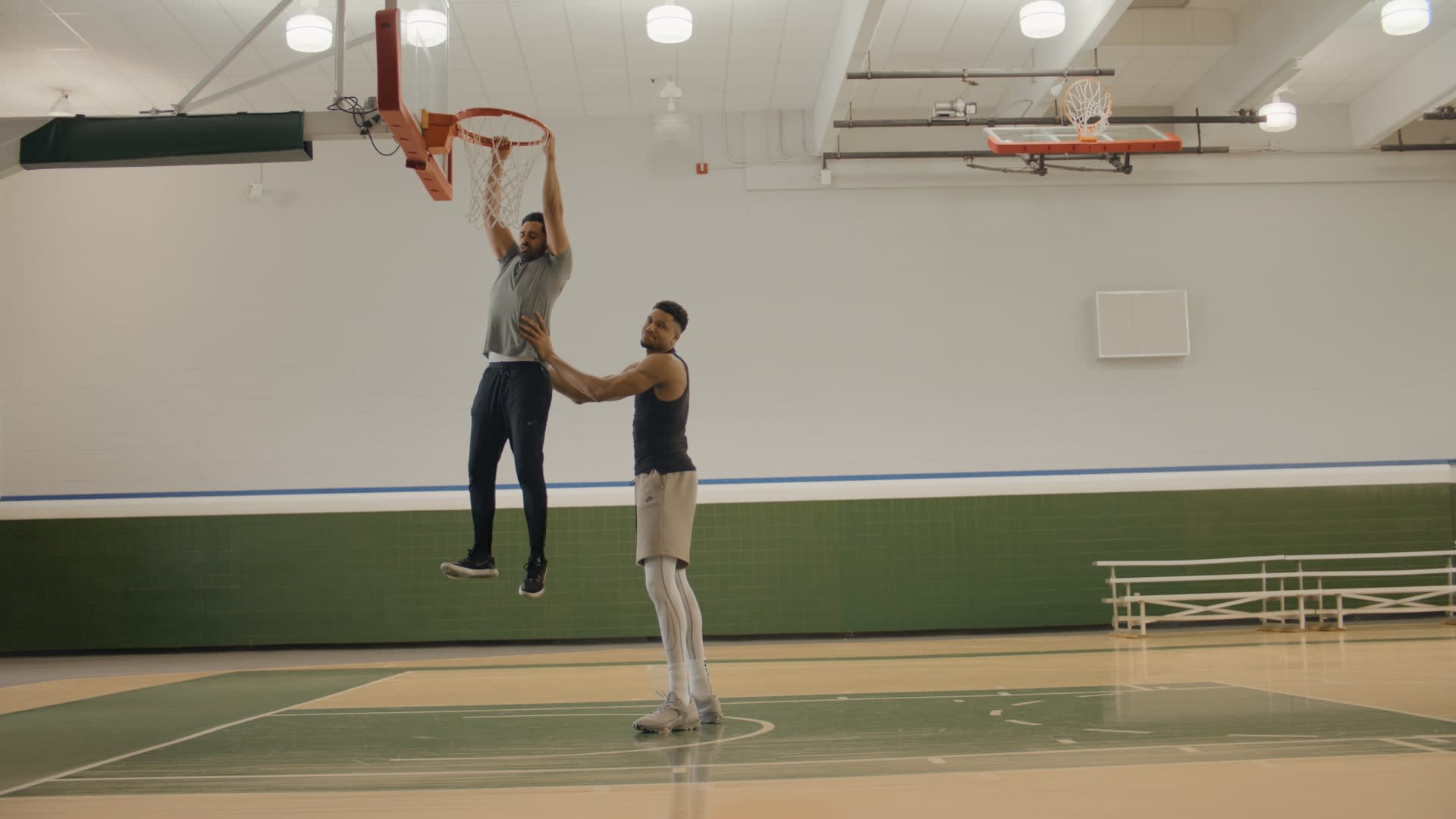 Hasan Minhaj dunking with some help from Giannis Antetokounmpo in WhatsApp ad
