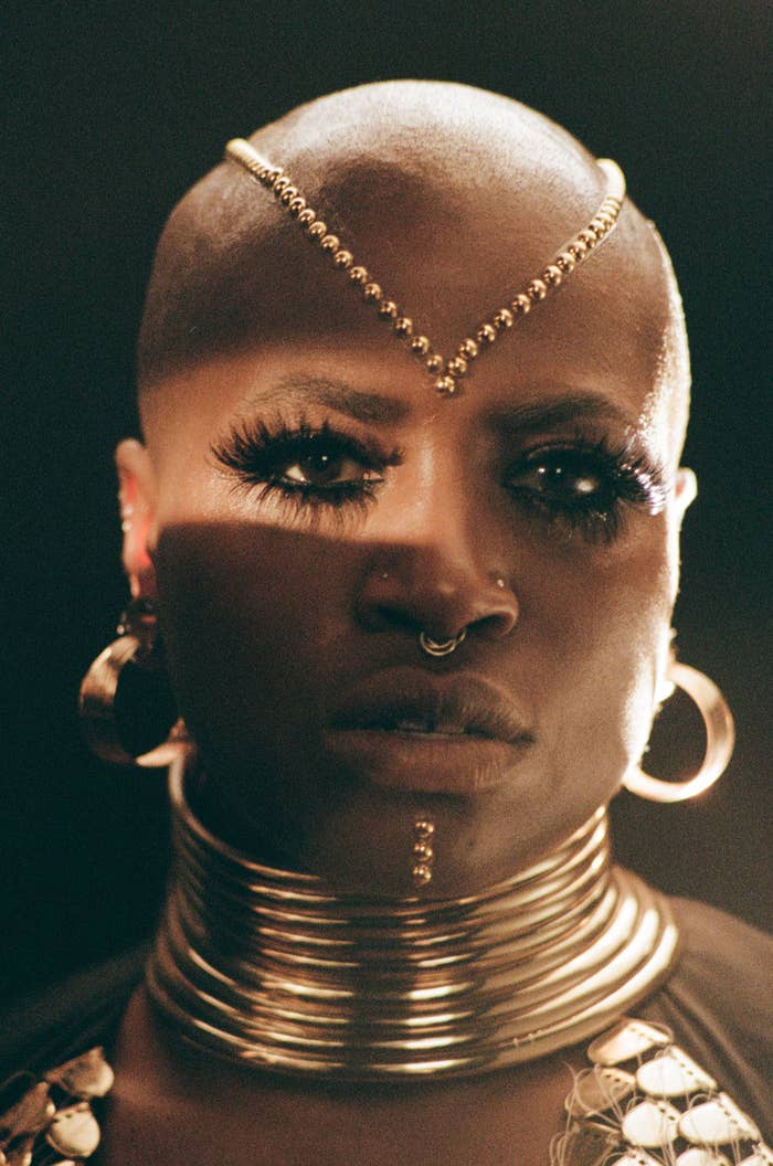 Toronto artist SATE poses with gold jewelry