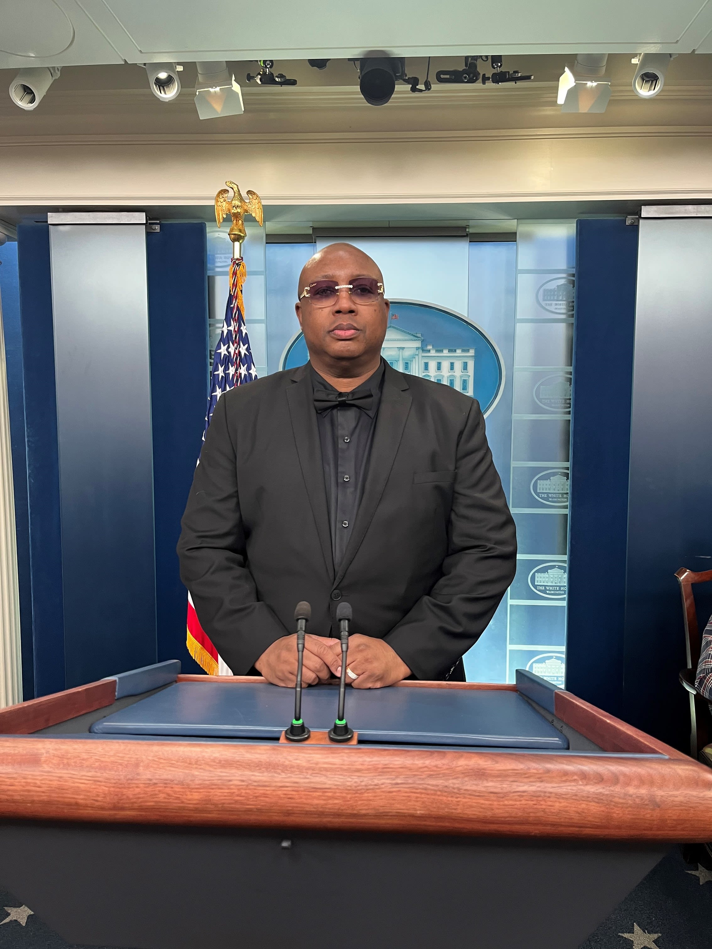 E-40 photographed at podium in White House briefing room.