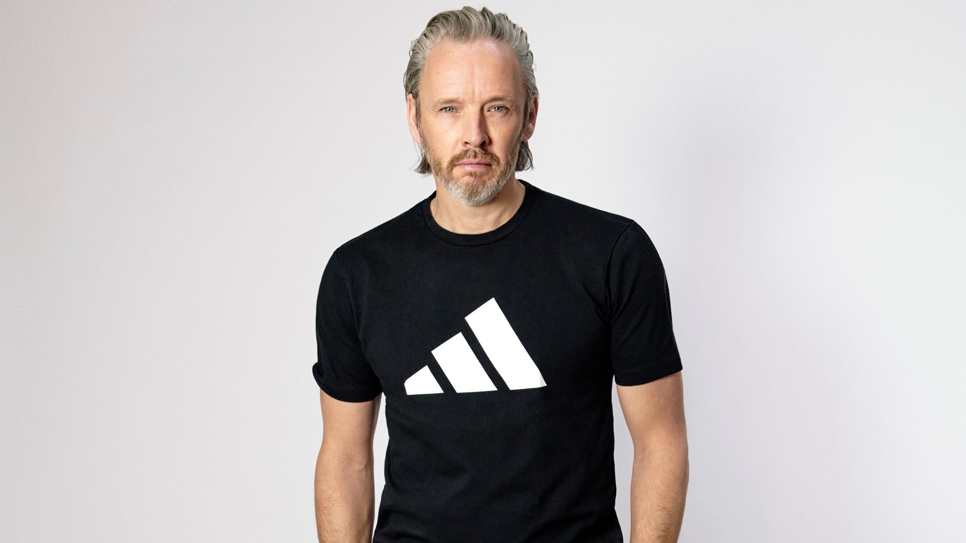 Adidas chief creative officer Alasdhair Willis in March 2022 wearing a black Adidas tee shirt with a white Adidas mountain logo