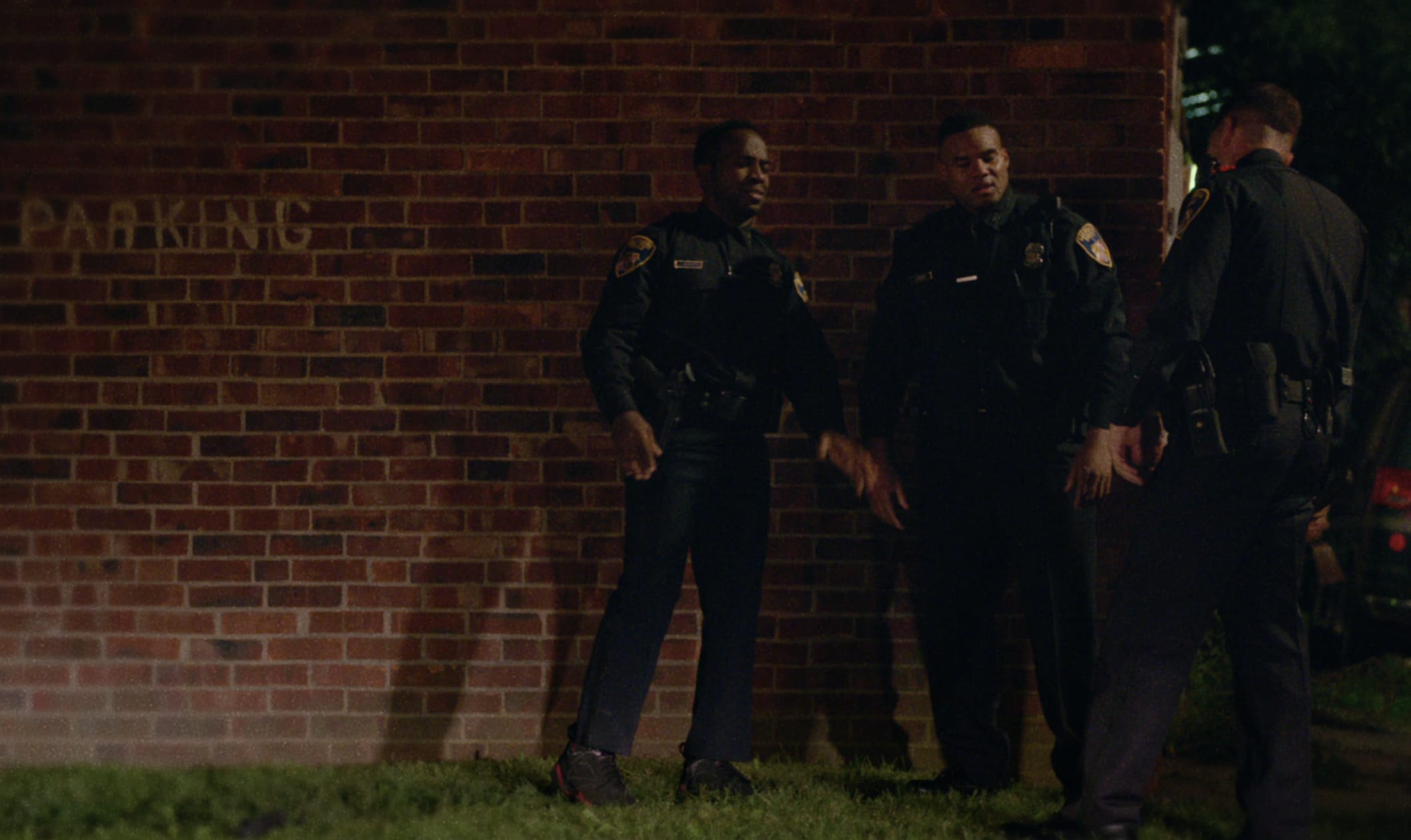 Police officers in Baltimore in the HBO series We Own This City, one of them wearing Air Jordan 7s