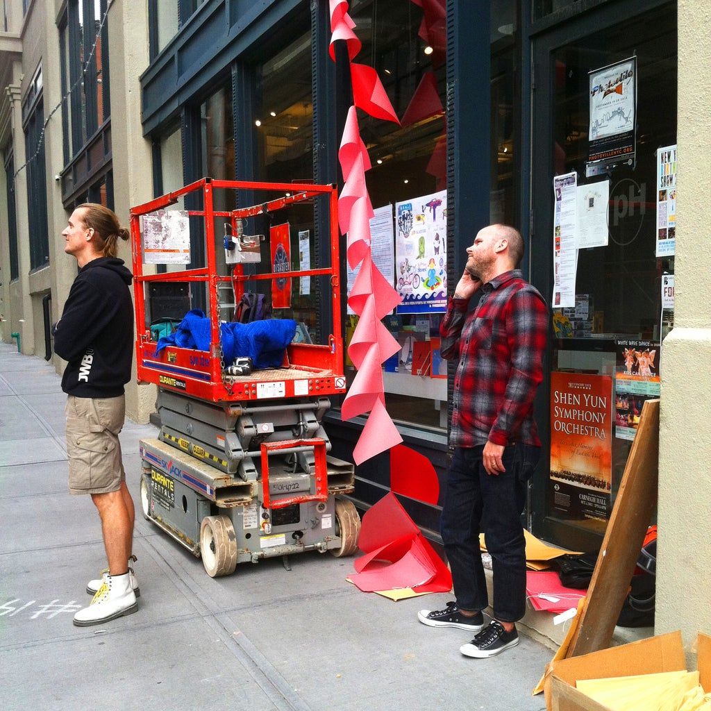 Goen oversees the hanging of "Who Is Chelsea Manning" a few short hours before the festival began.