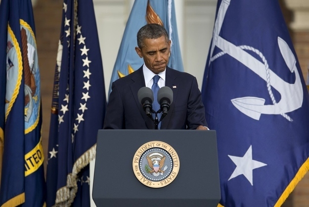 President Barack Obama pauses as he speaks during a memorial service for the victims of the Washington Navy Yard shooting at Marine Barracks Washington, Sunday, Sept. 22, 2013, in Washington. A gunman killed 12 people in the Navy Yard on Monday, Sept. 16, 2013, before being fatally shot in a gun battle with law enforcement.
