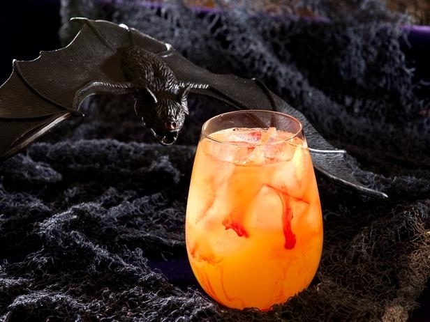 Blood Sucker Cocktail - shake up triple sec, vodka and pineapple juice, then strain and pour into a glass. Drip strawberry or raspberry puree along the sides of the glass to add streams of "blood."