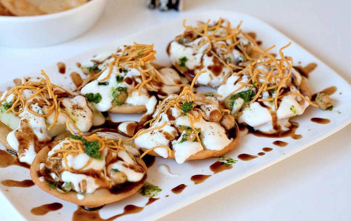 What It Is: Crispy, fried dough wafers served with boiled potatoes, boiled chick peas, chilis, yogurt, tamarind chutney, and several spices.Perfect For: A healthy and multi-flavored snack.Feels Like: Rewatching an old Bollywood movie with your mom, for the eighth time.