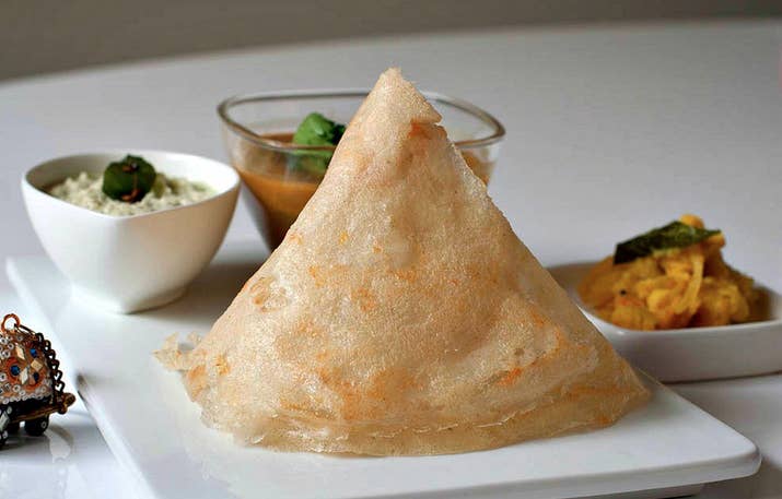 What It Is: A crispy, flat bread (similar to a crepe or pancake) made of rice batter, served with a lentil sauce (sambar) and a variety of chutneys.Perfect For: When you want breakfast to be the highlight of your day.Feels Like: Recounting last night's events the morning after a sleepover.