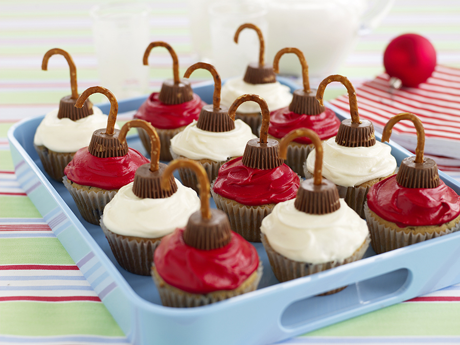 Cupcakes, colorful frosting, peanut butter cups, and pretzels are all you need!