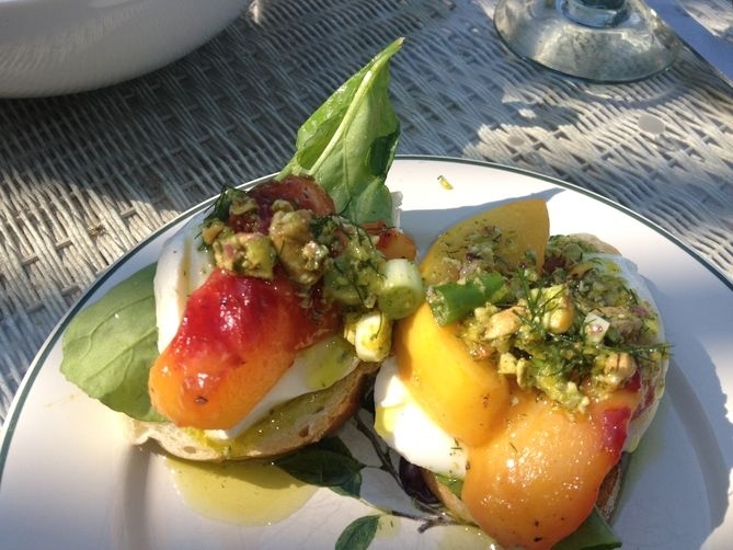 Explore mozzarella and persimmon crostinis, topped with Serrano ham and pistachio fennel oil.