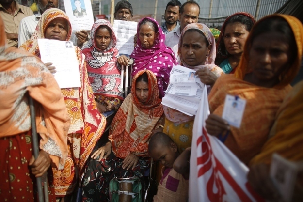 Survivors and relatives of garment workers, who are still missing after the Rana Plaza building collapse, take part in a protest in front of the site in Savar, on Nov. 24, 2013.