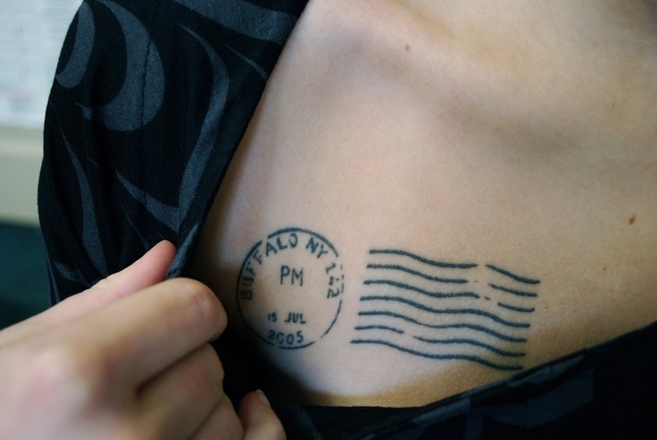 Tiny custom stamp tattoo in fine line located on the