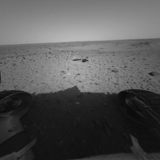 This image shows the rover’s perspective of its first post-egress drive on Mars. Engineers drove Spirit approximately 3 meters (10 feet) toward its first rock target, a football-sized, mountain-shaped rock called Adirondack. The drive took approximately 30 minutes to complete, including time stopped to take images. Spirit first made a series of arcing turns totaling approximately 1 meter (3 feet). It then turned in place and made a series of short, straightforward movements totaling approximately 2 meters (6.5 feet).