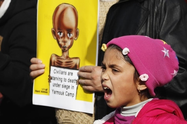 Jordanian and Palestinian demonstrators showed support for Palestinian refugees under siege in the Yarmouk camp during a solidarity sit-in front of the Red Cross offices in Amman on Jan. 4.