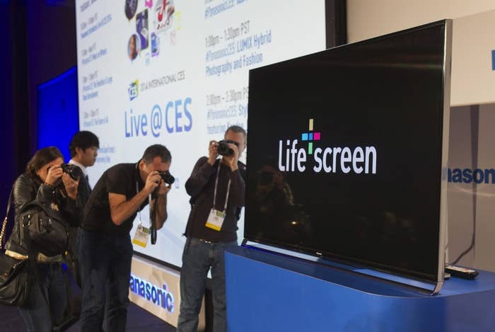 Journalists take photos of a Panasonic television with Panasonic "Life Screen" technology during the 2014 Consumer Electronics Show (CES) in Las Vegas, Nevada, January 6, 2014.