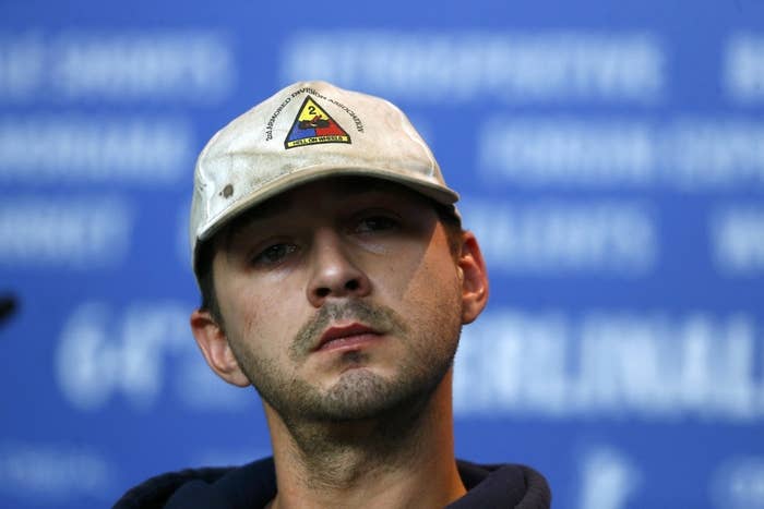 Shia Labeouf Is Sitting In A Room With A Bag Over His Head For An